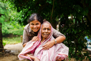 elderly and caregiver smiling